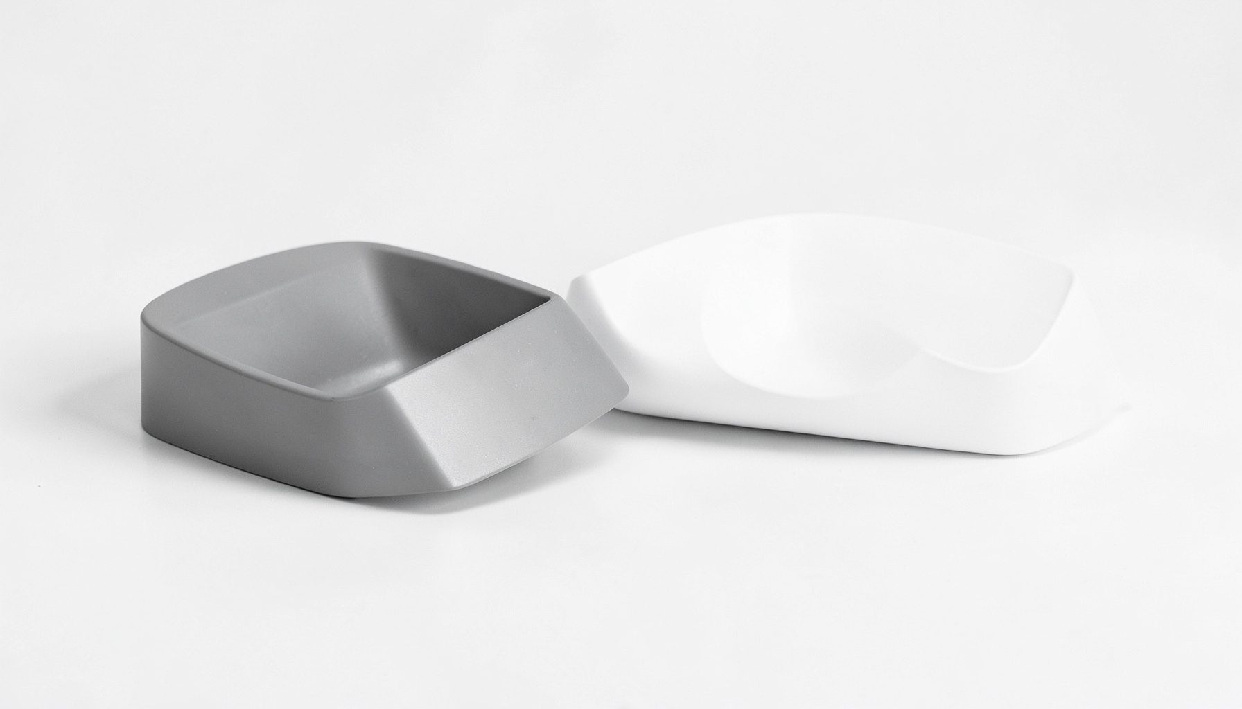 Duotone product arrangement on a clean surface, crisp graphite and soft white tones, commercial catalog style